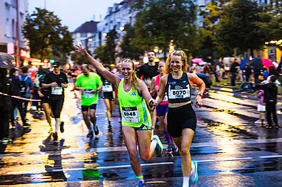 Two women on the track with a lot of joy on their faces 